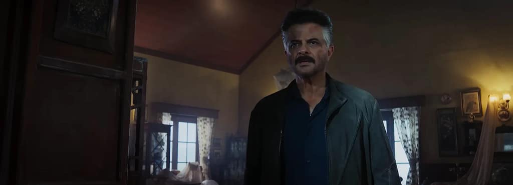 An intense close-up shot of a wounded Vikrant Kaul (Anil Kapoor), wearing a dark jacket in a dimly lit house in Alpha (2026). Image credit: Alpha -film still via YRF/YouTube.
