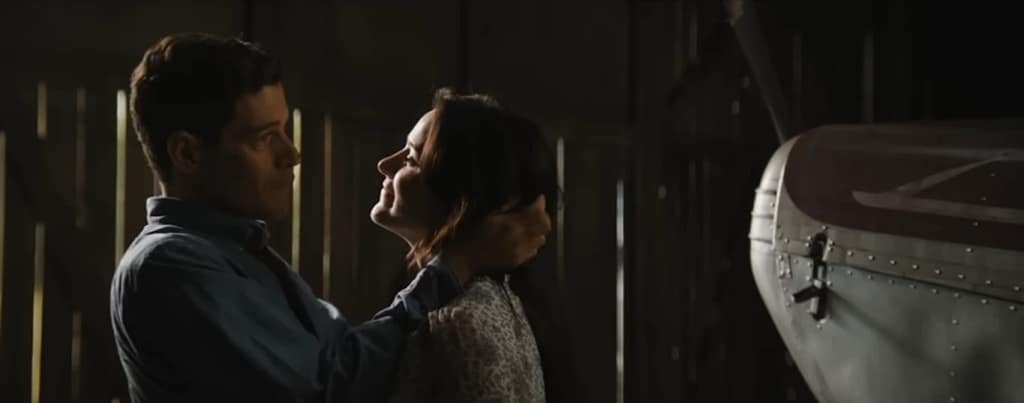 Charlie Heller (Rami Malek) and Sarah Heller (Rami Malek) sharing a quiet moment in The Amateur (2025). 
