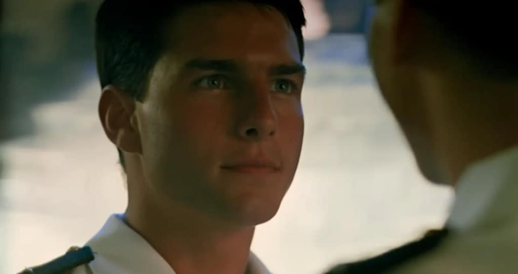 A young Tom Cruise smiling in naval uniform as Pete “Maverick” Mitchell in the 1986 film Top Gun.Image credit: Top Gun (1986) - film still via Paramount Movies/YouTube.