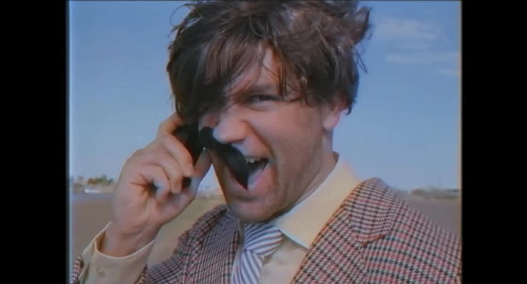 Tyler Breeze as the villainous banker Mr Mackelroy laughing maniacially while his fake mustache gets half peeled off by the wind.