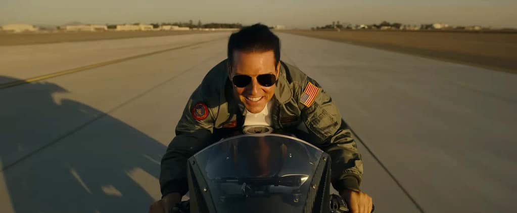 Tom Cruise riding a high-speed motorcycle down an airfield runway in Top Gun: Maverick (2022). Image credit: Top Gun: Maverick (2022) - film still via Paramount Pictures/YouTube.