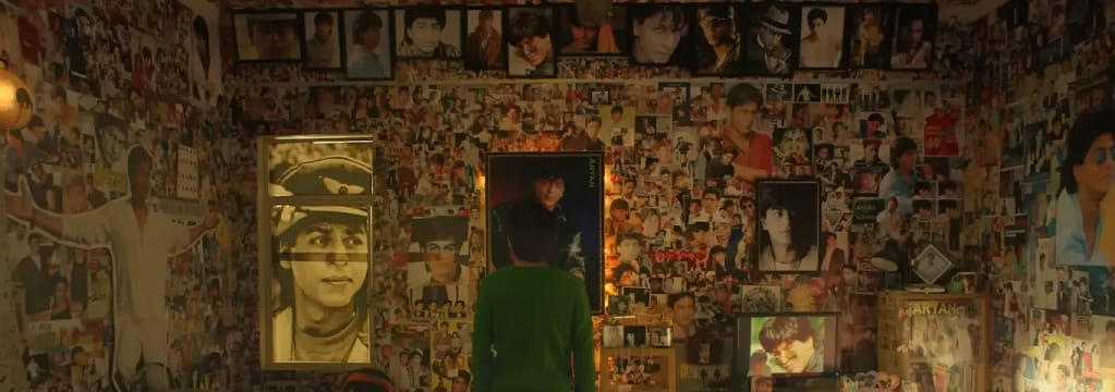 Gaurav standing in his room covered wall to wall with Aryan Khanna posters in Fan (2016).