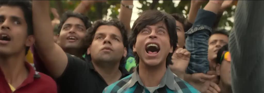 Shah Rukh Khan as Gaurav Chandna celebrating joyously in a crowd scene from Fan (2016).