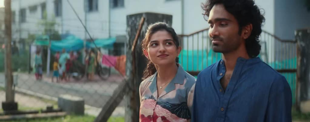 Mamitha Baiju as Kural looking at Pradeep Ranganathan as Agan while walking together outdoors in Dude (2025).