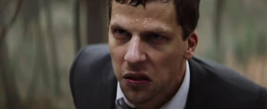 Jesse Eisenberg as Vincent Zaleski sweating heavily with an intense, obsessed facial expression outdoors in a scene from The Hummingbird Project. Image credit: The Hummingbird Project (2018) film still - via Rotten Tomatoes Trailers/YouTube.