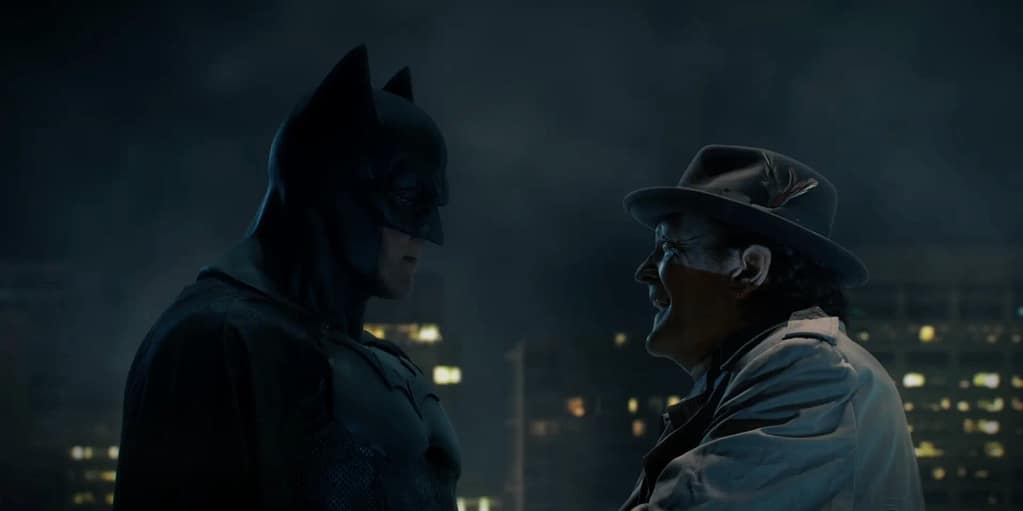 Kevin Porter as Batman standing face-to-face with Michael Madsen as Lieutenant Harvey Bullock in a scene from Batman: Dying Is Easy (2021). Image credit: Batman: Dying Is Easy film still - via batinthesun/YouTube.