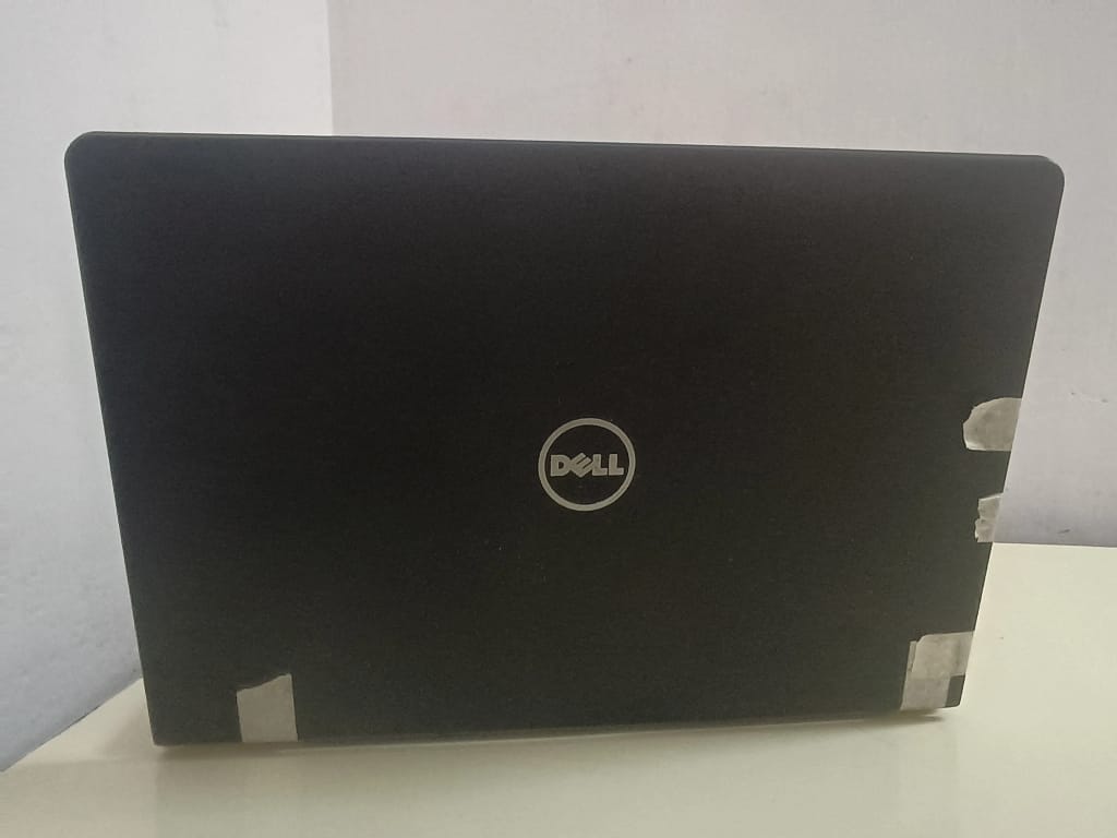 The back and hinge area of a laptop secured with tape to prevent the casing from separating.