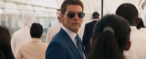 Tom Cruise wearing a blue suit and aviator sunglasses walking through a crowd in Mission Impossible Dead Reckoning (2023). Image credit: Mission Impossible Dead Reckoning (2023) - film still via Paramount Pictures/YouTube.