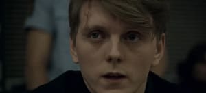 Close up shot of actor Jonas Strand Gravli as Viljar Hanssen in the movie, “22 July” (2018) displaying physical scars and emotional trauma.